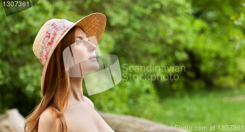 Image of Young beautiful girl with hat posing outdoor