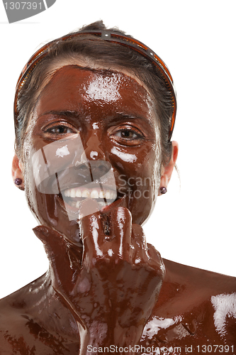 Image of young woman having a chocolate face mask