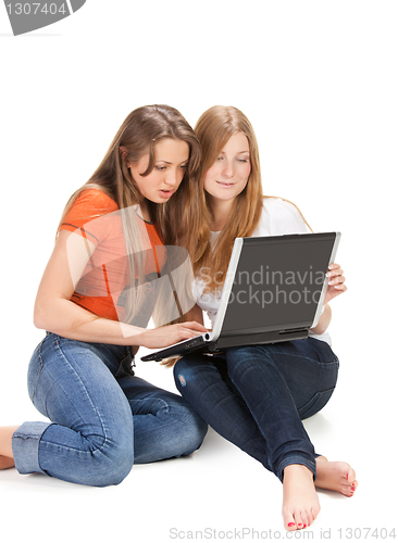 Image of two young happy student girl work on laptop