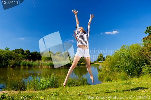 Image of young woman exercising outdoor in summer