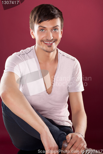 Image of Young handsome man in a white shirt over red