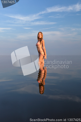 Image of girl posing in the Water at sunset,