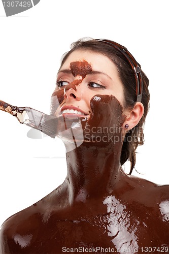 Image of young woman having a chocolate face mask