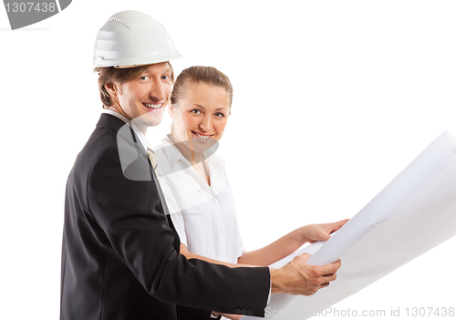 Image of An architect wearing a hard hat and co-worker
