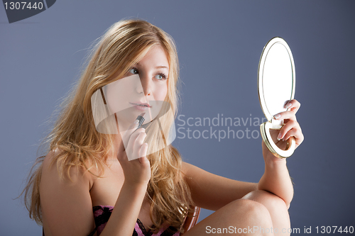 Image of beautiful woman with mirror