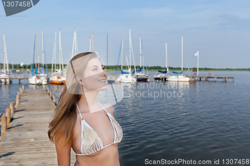 Image of Attractive young woman near the yachts