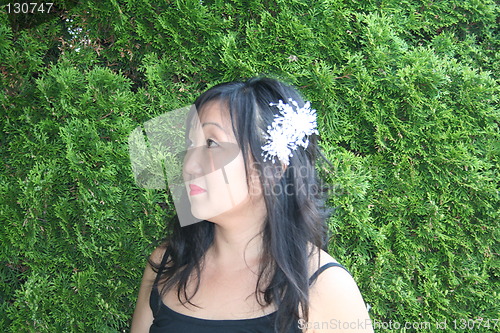 Image of Woman in profile with flower in her hair