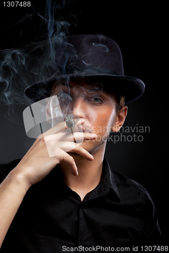 Image of Gangster look. Man with hat and cigar.