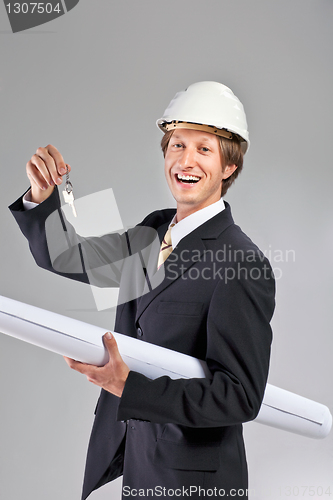 Image of smiling engineer giving keys from apartment