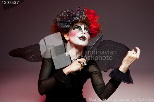 Image of woman mime with knife