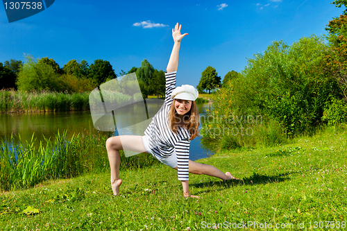 Image of young woman exercising outdoor in summer