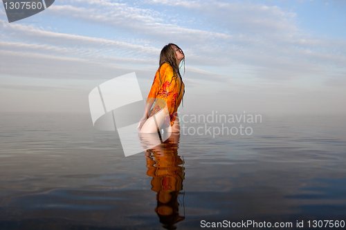 Image of girl posing in the Water at sunset