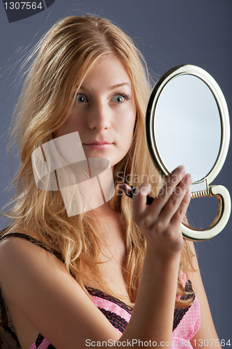 Image of beautiful woman with mirror