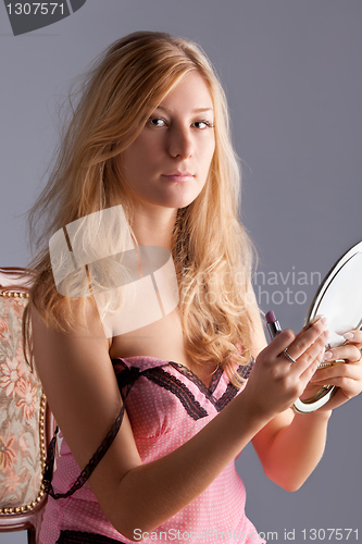 Image of beautiful woman with mirror