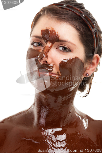 Image of young woman having a chocolate face mask