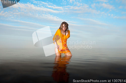 Image of girl posing in the Water at sunset