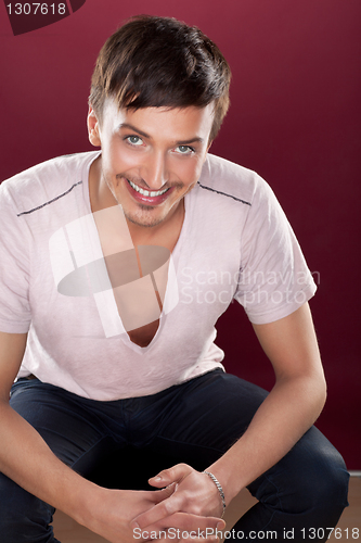 Image of Young handsome man in a white shirt over red