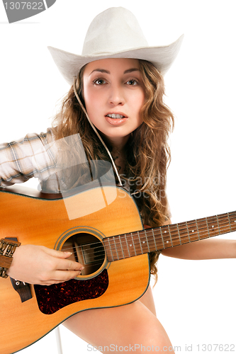 Image of Sesy cowgirl in cowboy hat with acoustic guitar