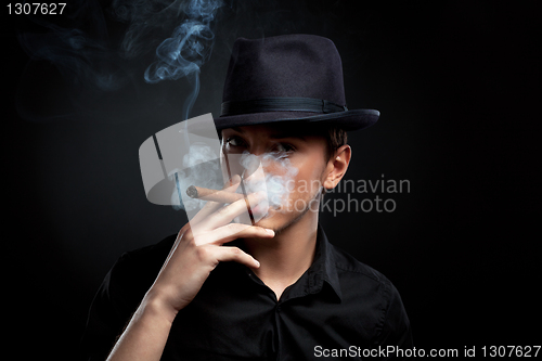 Image of Gangster look. Man with hat and cigar.
