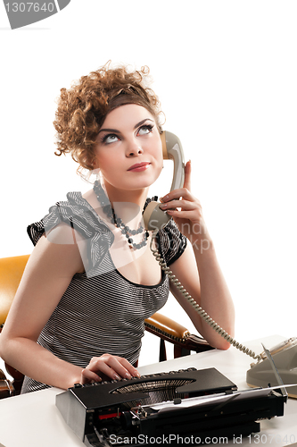 Image of Businesswoman taking telephone call in office