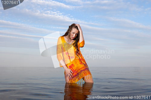 Image of girl posing in the Water at sunset