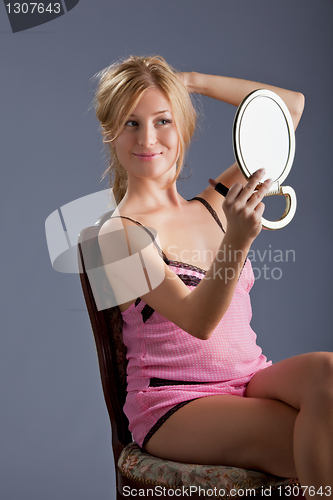 Image of beautiful woman with mirror