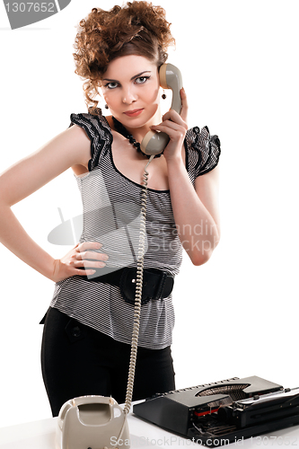Image of Businesswoman taking telephone call in office