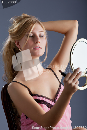 Image of beautiful woman with mirror