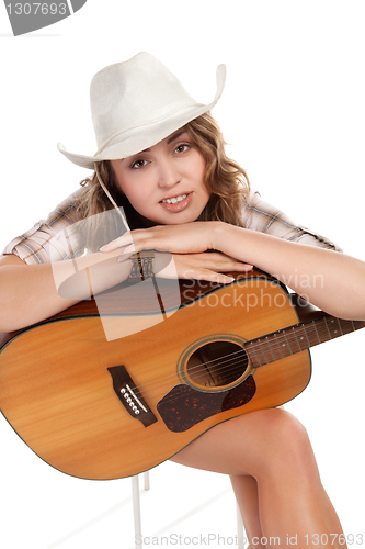 Image of Sesy cowgirl in cowboy hat with acoustic guitar