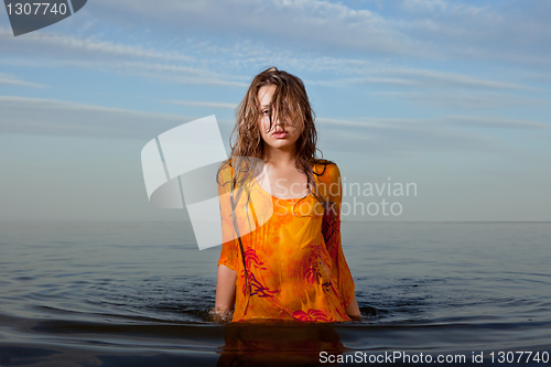 Image of girl posing in the Water at sunset