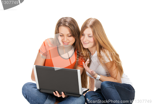 Image of two young happy student girl work on laptop