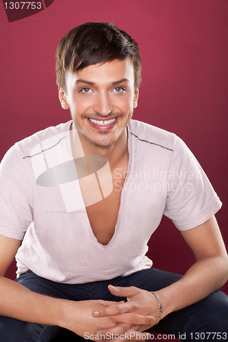 Image of Young handsome man in a white shirt over red