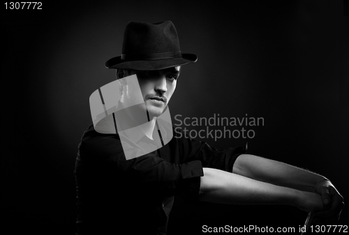 Image of Gangster look. Man with hat and cigar.