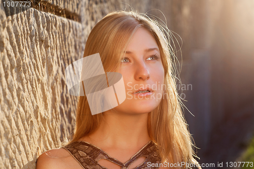 Image of Young woman outdoors at sunset