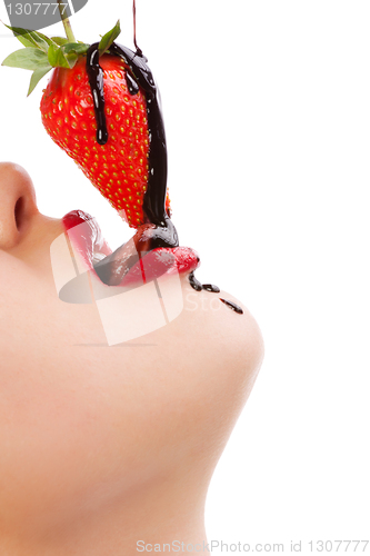 Image of girl eating strawberry with chocolate sauc