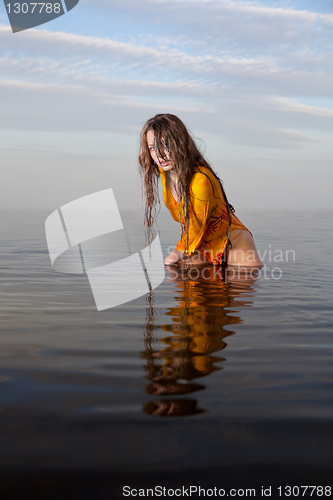 Image of girl posing in the Water at sunset