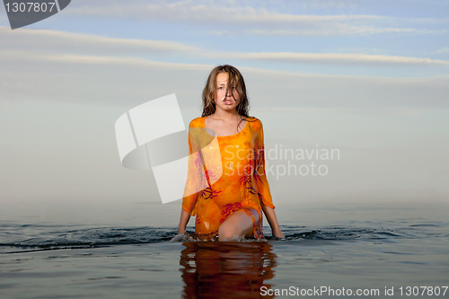 Image of girl posing in the Water at sunset