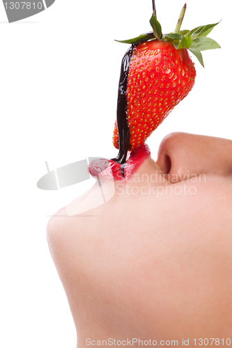 Image of girl eating strawberry with chocolate sauc