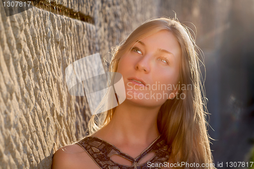 Image of Young woman outdoors at sunset