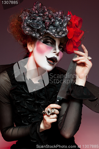 Image of woman mime with knife