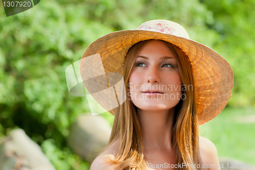 Image of Young beautiful girl with hat posing outdoor