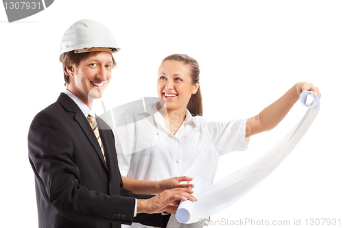 Image of An architect wearing a hard hat and co-worker