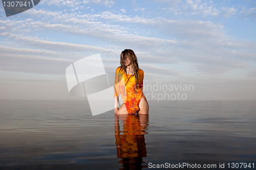 Image of girl posing in the Water at sunset