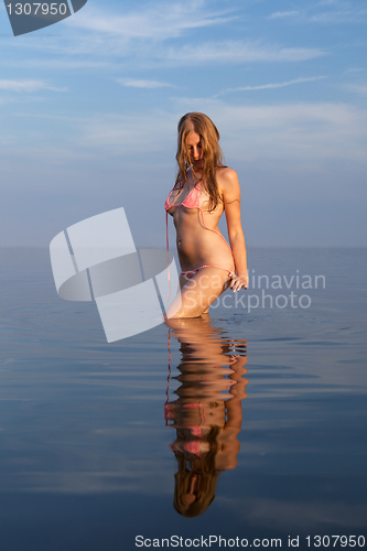 Image of girl posing in the Water at sunset,