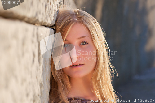 Image of Young woman outdoors at sunset