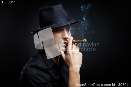 Image of Gangster look. Man with hat and cigar.