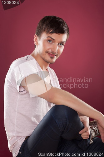 Image of Young handsome man in a white shirt over red