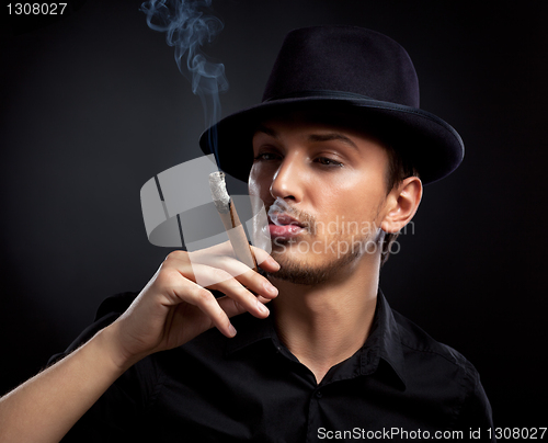 Image of Gangster look. Man with hat and cigar.