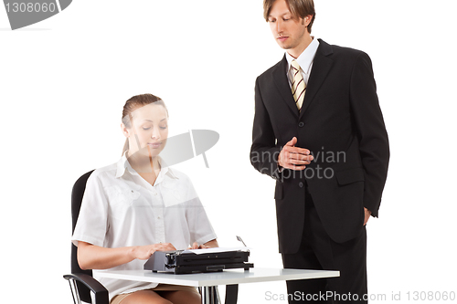 Image of Two businesspeople working with typewriter