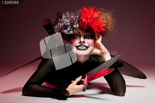 Image of woman mime with knife